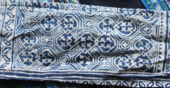 Indigo batik on cotton. This intricate design has been recycled - once used in a skirt, it's now used as straps on a baby-carrier that has been used for a half-dozen children. 