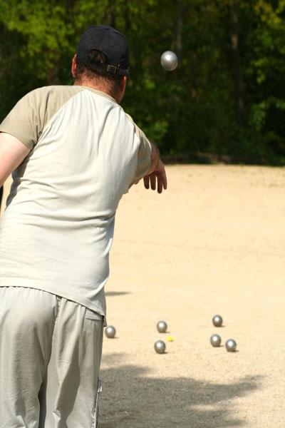 A casual game of pétanque. This sport is part of the 25th SEA Games in Laos.