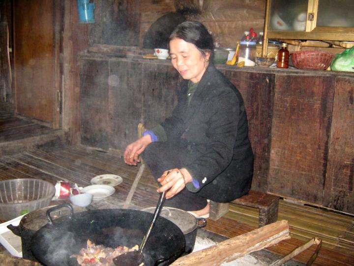 Mama cooks our dinner on an open fire in Pac Ngoi, Ba Be National Park, Vietnam