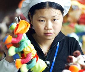 A machinist finishes sewing a toy in a factory in the southern Chinese city of Shenzhen.