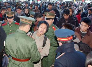 Travellers wait at Beijing West Railway station in Beijing to catch their trains for the annual trip home to visit relatives in celebration of Chinese New Year.