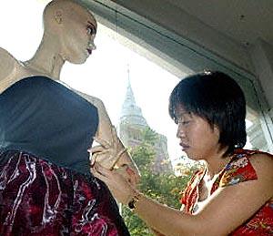A Thai design student works on a creation during her fashion course at the Wat Dammamongkol temple in Bangkok.