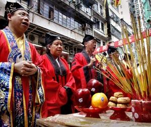 People chant during a ceremony of the Hungry Ghost festival in Hong Kong.