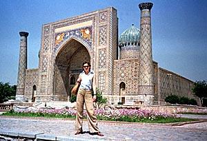 A tourist poses in front of Ragestan palace, in the ancient Uzbek city of Samarkand. This large city of Islamic art was founded in V century B.C.