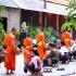 Monks are given rice by faithful women  on their early morning walk through Luang Prabang