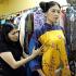 Designer Dang Thi Minh Hanh checks one of her creations with a model at her studio in Ho Chi Minh City, Vietnam.