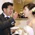 Yuichi Nakasho feeding a piece of cake to his bride, Yuko Sasakawa, during their wedding reception at a wedding hall in Tokyo.