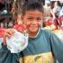 A boy helps his mother sell souvenirs near the front entrance to Angkor Wat.