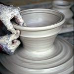 Skilled hands breathe life into the dull gray earth.