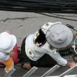 Mother with her small child balancing on the back of her bike
