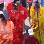 stilt-walkers in traditional opera costumes during the Cau Ngu Festival in Phan Thiet