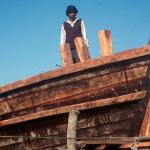 A dhow builder at work, in Veraval Harbour. Veraval, Gujarat, India.
