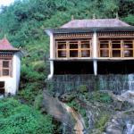 Gangtok, Sikkim, India: A water-driven roadside prayer wheel solicits safety for passing motorists.