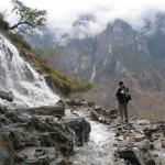 A waterfall across the path through Tiger Leaping Gorge
