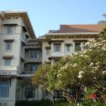 Hotel front with frangipani. After the years of neglect, all the hotel had to offer was its architectural integrity. The resurrection was based on that foundation. Beginning in 1996, under the sponsorship of Raffles International Limited, the main building was renovated, restored, and refurbished.