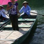 Our guide hopped into a wooden boat and protected us from the sun with her parasol.