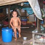 A child in her lean to home on Lake Tonle Sap