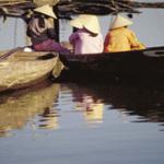 Small boats on the bank of the Thu Bon River. From the 17th to the 19th centuries Hoi An was among the most active ports in Southeast Asia. Today, fishing boats still go down the Thu Bon River to the South China Sea for their catch.