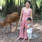 Recipients of a calf displaying their newest member of the family.