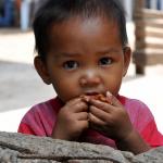 Green & Graphic Getaways, young boy eating lechon