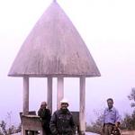 URAHO, EAST TIMOR Villagers of Uraho relax in the mists, under a traditional-roofed bus shelter.