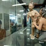 A woman visitor looks at a pornographic clay of early 19th century at the Museum of Ancient Chinese Sex Culture in Shanghai.