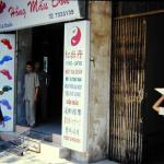 Parking attendants at Hong Mau Don massage parlor, where the first floor serves as a motorbike parking garage.