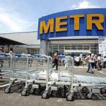 An employee pushes handcarts in front of the first Metro Cash and Carry wholesale center in Hanoi. Germany's Metro Group plans to open eight wholesale centers in Vietnam.
