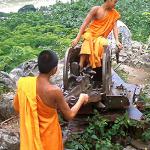 Novice monks play with a Russian anti-aircraft gun on top of Phou Si, above the old royal capital of Luang Prabang. Decades of war left many unwanted legacies, including unexploded ordnance.