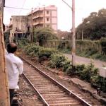 Bombay, India. Then there are India's trains: the cattle-car-like Bombay commuter trains crashing under the flyover at Mumabai Road, packed so full that their passengers hang out of their doors. Boarding a train is a scrimmage; leaving is a kind of ejection.