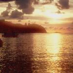Sun sets over the waters of the bay at the popular Pantai Pasir Bogak.