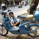 A mecanic puts the last finishing touch on a Chinese-made electric motorbike before its delivery in front of a bicycle shop in downtown Hanoi.