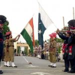Pakistani paramilitary troopers with their Indian counterparts lower down their respective national flags at the Joint Check Post (JCP) at the Wagah border crossing between Pakistan and India.