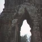 Siem Reap, Cambodia. Five gates breach the wall of Angkor Thom - four at the compass points, one to the East-Northeast. Four stone faces looking outward cap each gate.
