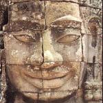 Siem Reap, Cambodia. Just a ways north from the South Gate is the Bayon, the most otherworldly Angkor monument. Here the faces of the South Gate are multiplied. 37 towers remain, each with four faces. Some, from a distance, do not resemble faces so much as piles of stone; others seem cast from the faces of the very gods. Their expressions are peculiar: the serene smiles formed by thick lips, the gently slanted eyes lacking irises, the elongated ears, the exaggerated eyebrows. Their French discoverers thought these faces sinister; certainly they are ambiguous -- eerily extraterrestrial.