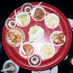 The khan, or small bowls, ring the toke, or table, centerpiece of the northern khantoke dinner.