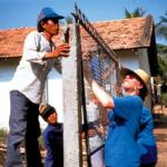 Volunteer Frank Severson works side-by-side with a local man in Tan Hiep.
