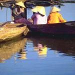 Small boats on the bank of the Thu Bon River. From the 17th to the 19th centuries Hoi An was among the most active ports in Southeast Asia. Today, fishing boats still go down the Thu Bon River to the South China Sea for their catch.