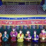 The puppeteers line up in front of the screen at the end of the performance.