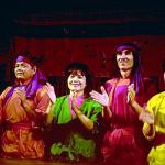 The puppeteers line up in front of the screen at the end of the performance.