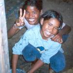 Pekray and her friend help clean up after dinner.