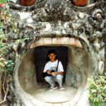 Our young guide La poses inside the mouth-like entrance to 'Hell.'