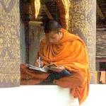 A monk at Luang Prabang's Wat Saen bundles up on a cold February day.