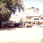 To the left, hidden within the welcome shade of a rare tree, is the fountain at the center of the Vientiane. Surrounding the fountain in the blazing sun are cafes and bakeries.