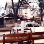 In the center of the picture may be seen, fittingly enough next to a Pepsi sign, the red hammer-and-sickle flag, emblem of Lao's continued devotion to Marxism.