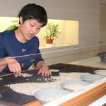 Showing what makes a good pearl. They sift through thousands of pearls to find matches by color, size, and luster.