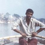 This man's occupation is rowing tourists up and down the great river, meanwhile explaining to them what they see on its banks. Unlike him, the photographer had to hide under a shawl from the harsh sun.