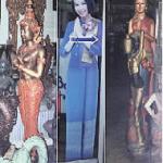 The wai appears commonly in Thai sculpture: far left in bronze, far right in wood. The life-like woman in the middle is a cardboard cut-out advertising Thai Airways.
