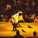 Sumo is the national sport of Japan, in which two very large wrestlers attempt to force each other from a circular ring measuring 4.5 meters in diameter. Many rituals and traditions are associated with the sport of sumo, and each wrestler's costume consist of nothing more than a colorful silk belt wrapped around his waist and loins. Sumo is year-round sport, with tournaments called basho that last for two weeks during alternate months. A sumo basho is held for each season of the year, (Hatsu, Haru, Natsu, and Aki), with two regional events in between. Sumo tournaments are festive, all-day affairs, attended by thousands of spectators bearing food and beverages to sustain them throughout the day's competition.