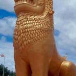 A golden lion stands watch, by the Tonlé Sap River